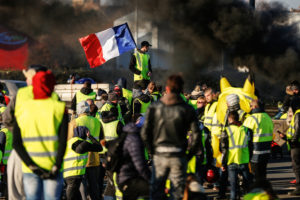 People block Caen's circular road on November 18, 2018 in Caen, Normandy, on a second day of action, a day after a nationwide popular initiated day of protest called "yellow vest" (Gilets Jaunes in French) movement to protest against high fuel prices which has mushroomed into a widespread protest against stagnant spending power under French President. (Photo by CHARLY TRIBALLEAU / AFP)